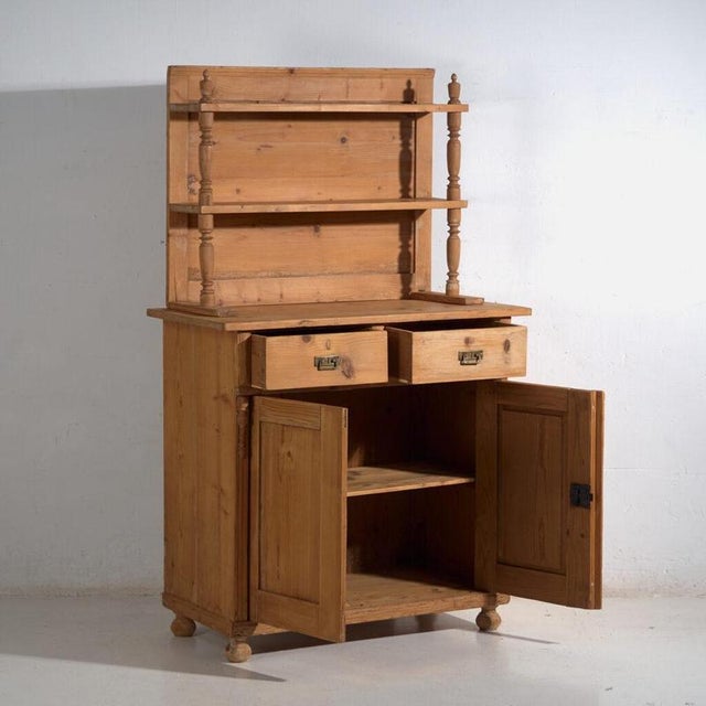 Antique pine kitchen dresser with lower cabinet and upper shelving, crafted in solid pine wood and originating from...