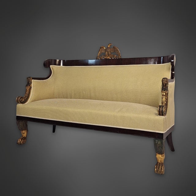 A three-piece Viennese Biedermeier seating group, consisting of a sofa and two matching armchairs. The frames are veneered...