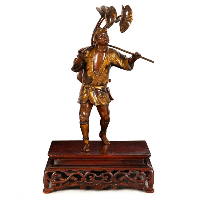 MEIJI BRONZE OKIMONO OF A FIRE WATCHMAN CARRYING A HYŌTAN Japan, late 19th century Patinated, lacquered, polychromed and...