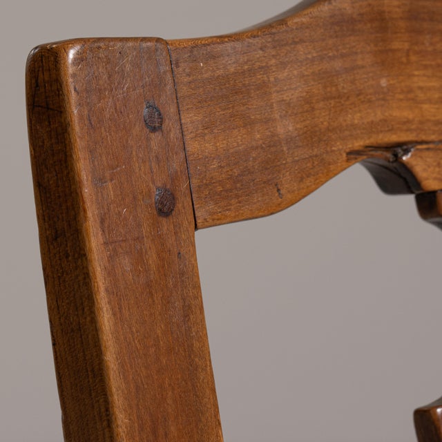 This set of four 19th century eclectic dining chairs from France, made in dark wood with pierced, carved backs. The carved...