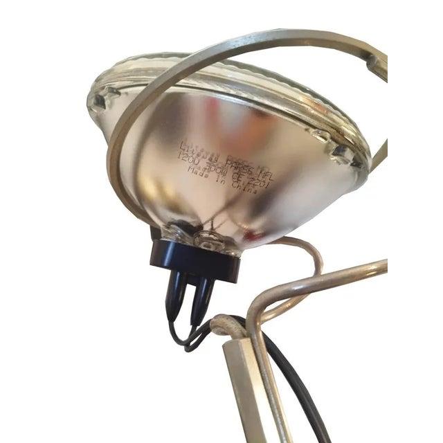 Floor lamp model Toio designed by Achille and Pier Giacomo Castiglioni for Flos in the 1960s. Black lacquered metal base,...