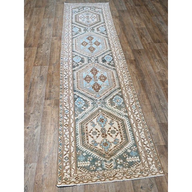 A beautiful antique Malayer Runner. This runner offers a blue palette with beige and brown accents.