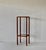 1970s Danish-style pedestal stand crafted from teak wood featuring two smoked glass surfaces. The smoked glass has no...