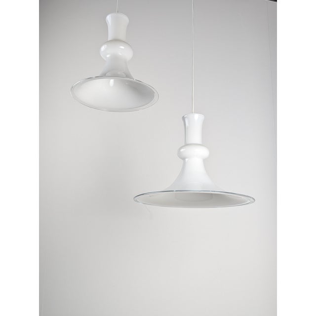 Elegant pair of pendant lamps designed by Michael Bang for Royal Copenhagen and produced by Holmegaard in the 1970s, a...