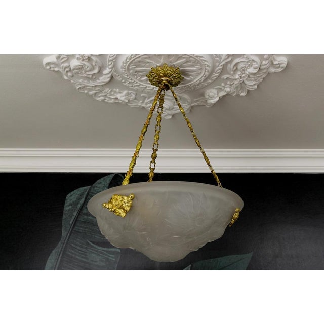 A beautiful French Art Deco single-light pendant light fixture with white frosted glass shade from circa the 1930s. This...