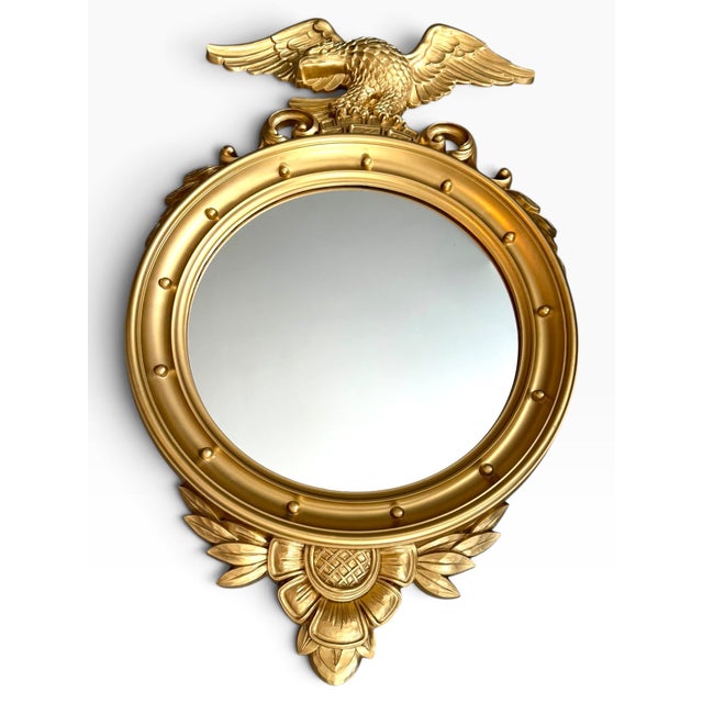 A striking vintage 1960s wall mirror featuring an elaborate gilt eagle crest surrounded by scrolling acanthus leaves,...