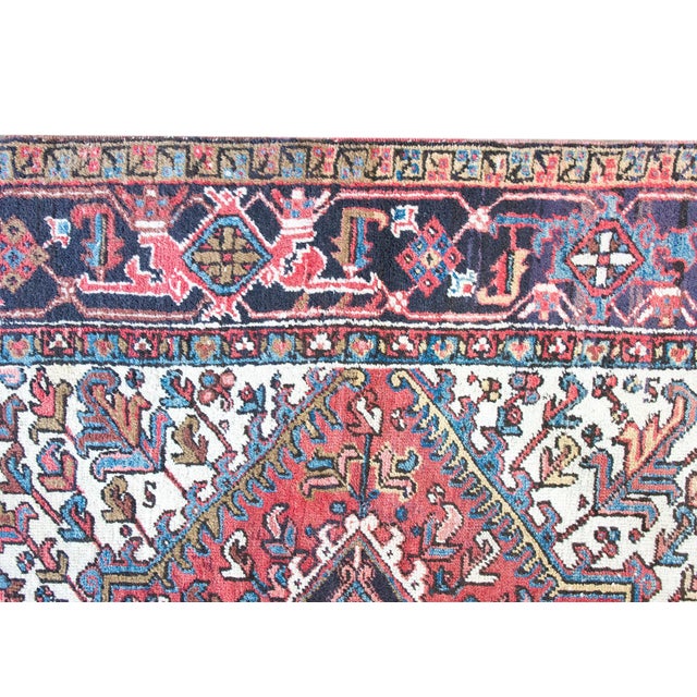 This early 20th-century Persian Heriz rug is a masterful example of the iconic craftsmanship from the Heriz region in...