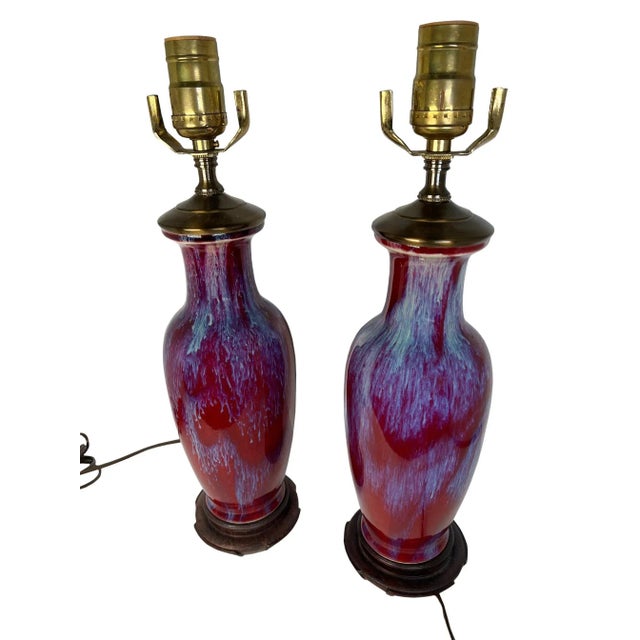 A pair of sung de boeuf vases converted into lamps with wood bases. 20th century China.