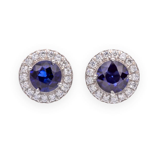This stunning pair of pre-owned Tiffany & Co. stud earrings from the Soleste Halo collection features gorgeous royal blue...