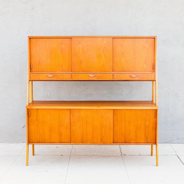 An exceptionally well-preserved two-tier sideboard or credenza by Randers Mobelfabrik, made in Denmark c. 1960s. A pair of...