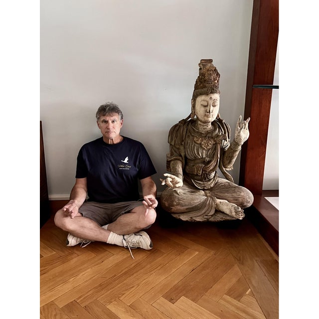 This is a large Chinese carved wood and polychrome sculpture of Guanyin (Avalokiteshvara), the bodhisattva of compassion,...