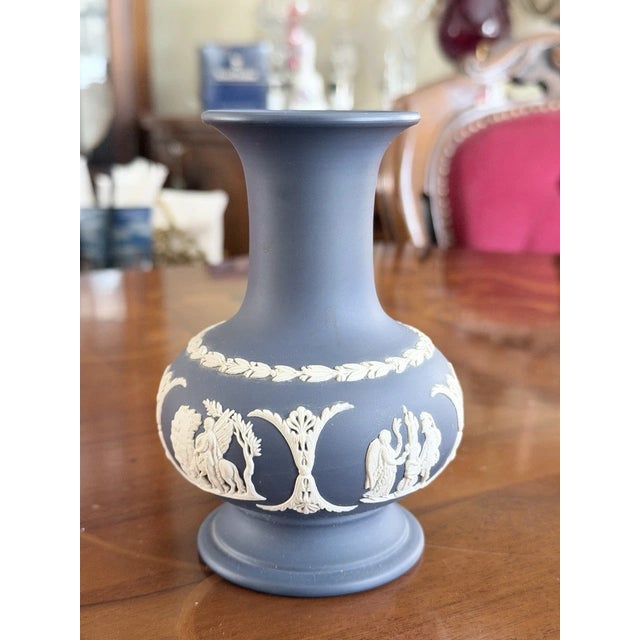 Beautiful vintage Wedgwood Jasperware vase in the classic Portland Blue color with white cameo relief detailing. This...