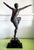 An exceptional and monumental Art Deco bronze dancer sculpture, executed after the celebrated designs of Demétre Haralamb...