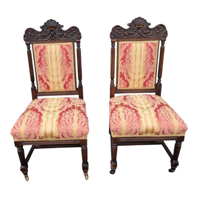 Beautiful pair of 19th century Victorian oak chairs with finely carved crest rails, fluted legs, and detailed...