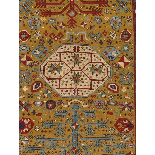 The Yellow field scattered with minor stylized flower heads, hooked panels and minute cross-motifs around a column of...
