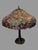 Handel Table Lamp Base with Vintage Floral Decorated Leaded Glass Shade In good original condition showing some typical...