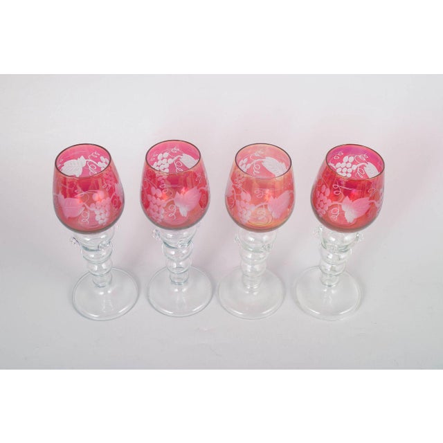 Set of four Bohemian red wine glasses. Red-tinted crystal glasses with cut and etched decoration in the classic Bohemian...