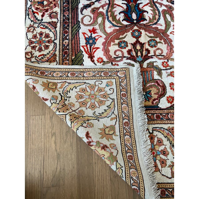 Finely hand-knotted vintage Turkish Hereke silk textile with a mihrab design and floral and botanical motifs. The silk has...