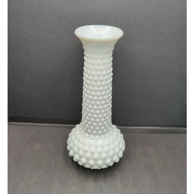 Crafted in the United States, this vase showcases the smooth, opaque white finish that defines traditional milk glass. Its...
