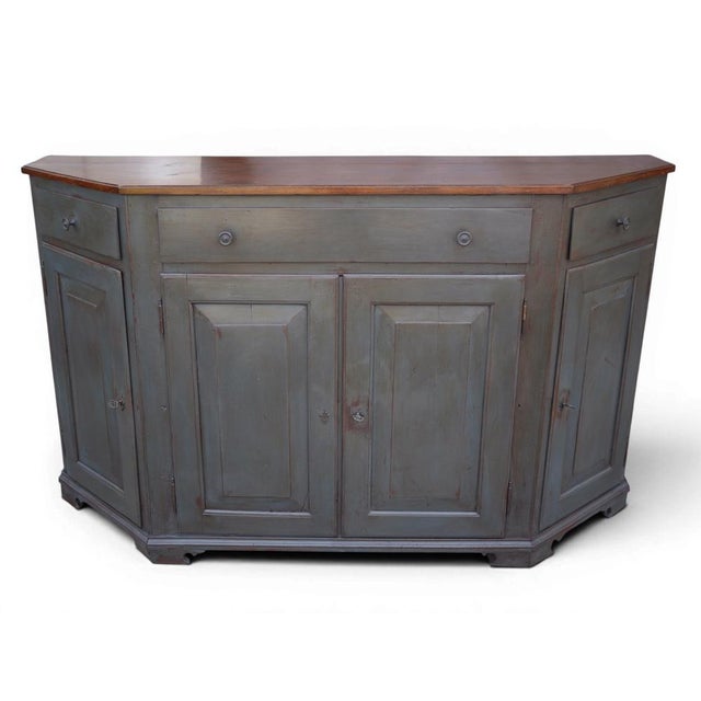 Antique Italian four-door painted sideboard An antique Italian canted sideboard in walnut, featuring a rich grey-blue...