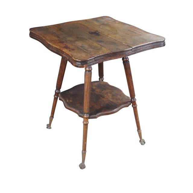 Antique Victorian Eastlake style parlor center pedestal table. Made of quartersawn oak featuring two tiers with serpentine...