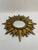 A stunning Mid Century Modern gilded resin Sunburst Accent Wall Mirror with varying lengths of rays. Circa Mid 20th...