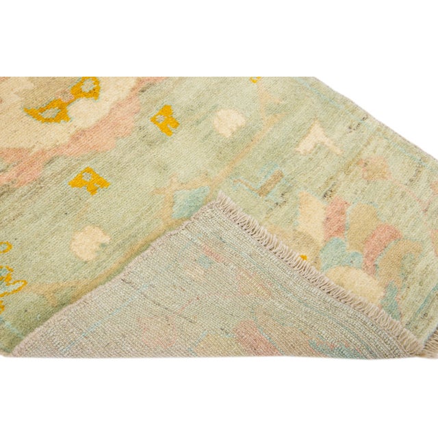Beautiful modern Oushak hand-knotted wool rug with a tan field. This piece has multicolor accents in a gorgeous all-over...