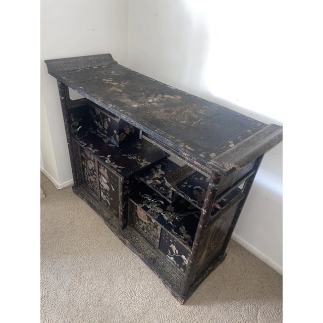 Antique Chinese Mother of Pearl Inlay Cabinet. From China in the late 19th century. Made of wood and ebonized lacquer with...