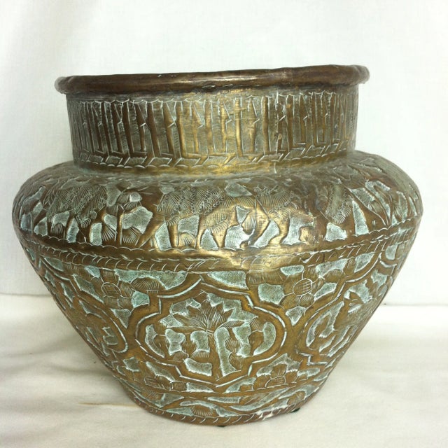 This large brass pot came to us by way of England, and we believe it originated somewhere in the Middle East. It is full...
