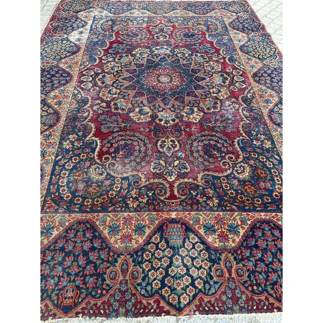 Nice antique distressed rug with beautiful floral design and nice natural colours, entirely and finely hand knotted with...
