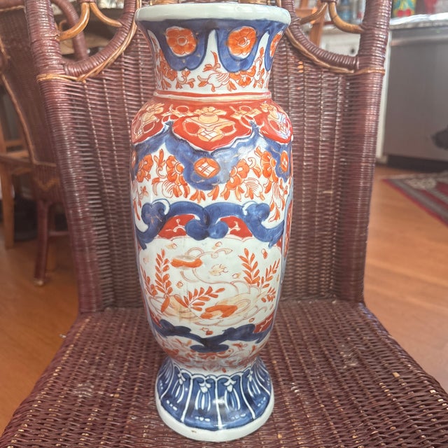 This is a 19th-century Japanese Imari porcelain vase from the Meiji period featuring hand-painted floral and bird designs...