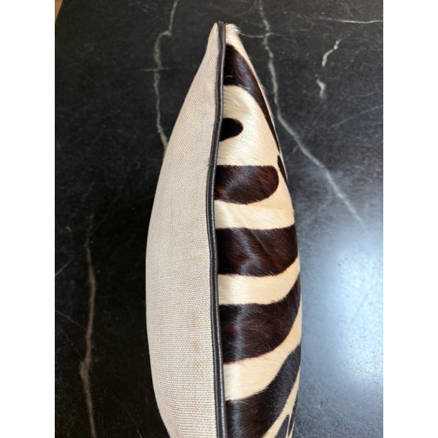 Very well-made faux zebra lumbar throw pillow printed on cowhide. Very soft. Brown leather piping and textured natural...