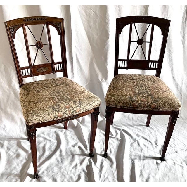 An exquisite pair of antique Edwardian side chairs in the Neoclassical / Sheraton Revival style, dating from the early...