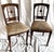 An exquisite pair of antique Edwardian side chairs in the Neoclassical / Sheraton Revival style, dating from the early...