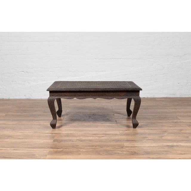 An Indian vintage coffee table from the mid-20th century, with handmade brushed metal patina over wood, hand-etched floral...