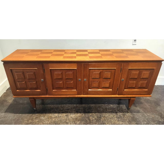 Solid oak sideboard, made in France in the 1960's. Traditional craftsmanship with a wealth of minimalist/Mid-Century...