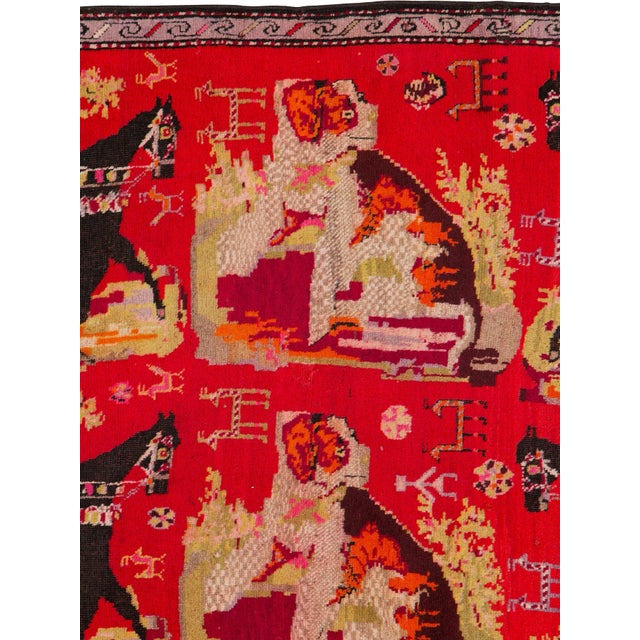 An early 20th century pictorial Karabagh rug. Measures: 4' 1" x 9' 10"