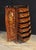 Elegant French Empire commode or tall boy of bombe form. Intricate marquetry inlay work on all sides showing floral...
