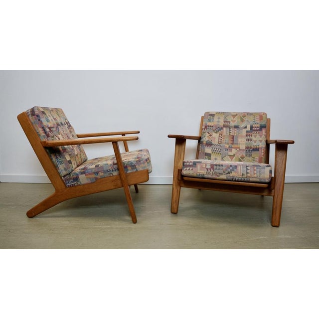 Pair of hans wegner ge-290 armchairs in teak wood. Experience the allure of scandinavian modern design with the hans...
