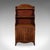 This is an antique waterfall bookcase. An English, flame mahogany petite chiffonier, dating to the Georgian period, circa...