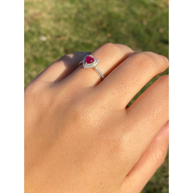 The 87th Avenue: Heart-Shaped Natural Ruby and Double Halo Natural Diamond Ring. This heartwarming ring features a...