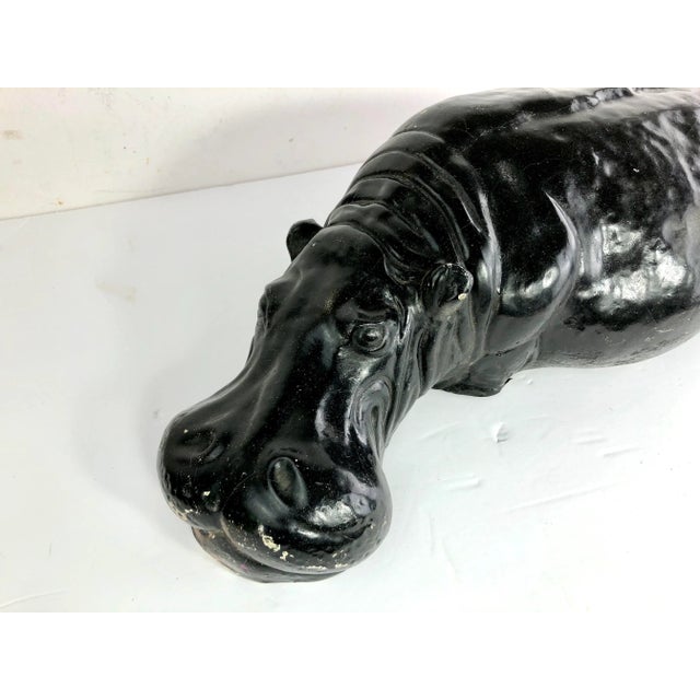 Vintage Painted Hippopotamus figure shown in a resting pose. Made of cast plaster.
