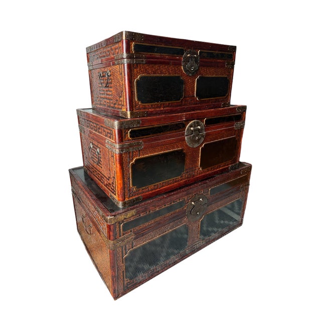 Late 20th-century Maitland-Smith chinoiserie bamboo chests with woven bamboo body, lacquered panels and brass hardware. A...