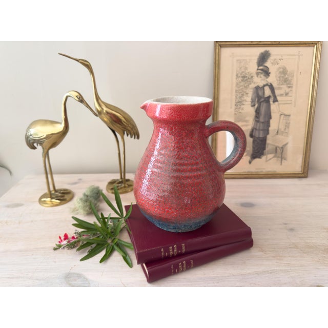 A striking vintage French ceramic pitcher by Accolay, dating from the mid-20th century. The sculptural form features a...