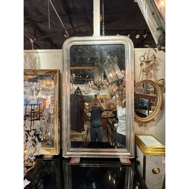 The French Silver Leaf Louis Philippe Mirror is a stylish and classic piece of home decor. Featuring a glistening silver...