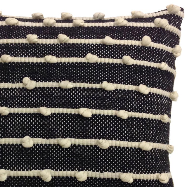 Charming and modern cotton pillow with cream stripes on black background. Unique hand knotted dots add texture and depth...