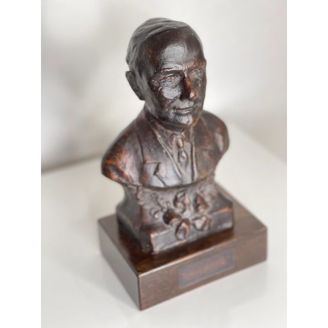 Heavy patinated bronze bust of a "Business Man" on a wooden base. It appears to have had an inscribed plaque attached in...