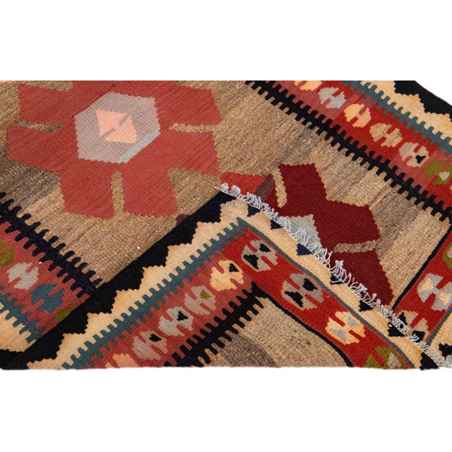 Beautiful vintage Turkish Kilim hand-knotted wool rug with a peach field. This piece has a rust frame and multicolor...
