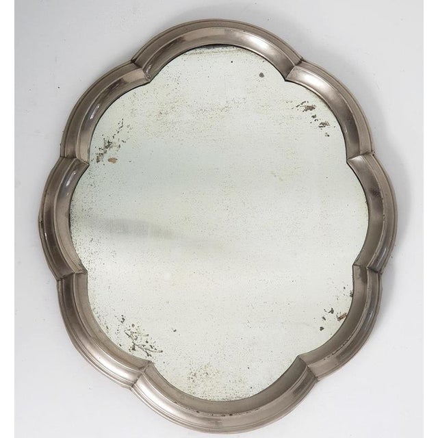 This is a unusual mirror made for decorating the table. The mirror is made with a frame in pewter in baroque style and...