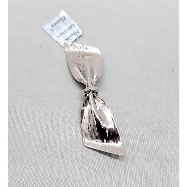Circa 1976 rhodium plated wavy bow brooch with security clasp. Marked "NAPIER©" on the back. Measures: 7/8 inches tall by...